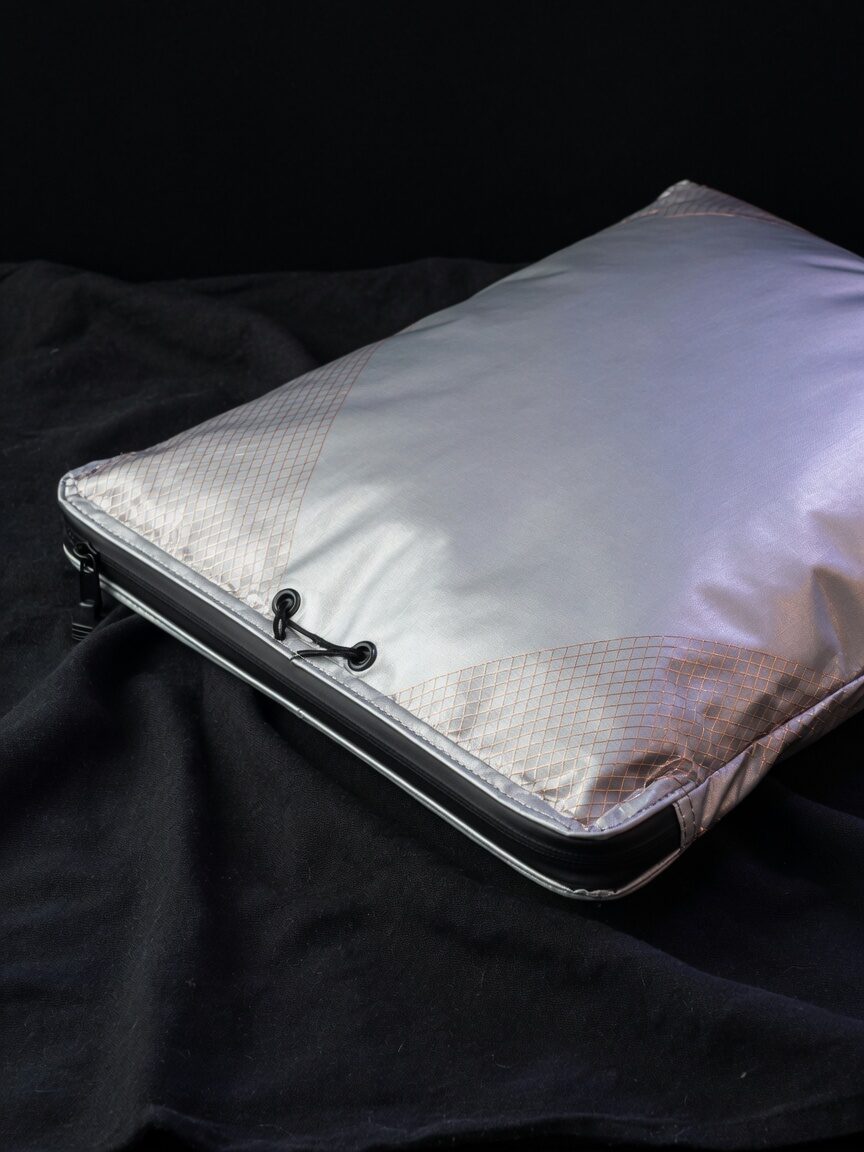 Sealed silver Faraday bag on black cloth, copper mesh in the fabric.